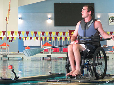 Wheelchair paddleboarding in the pool