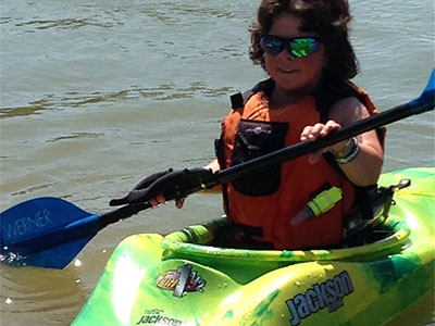 Young girl adaptive paddling kayak