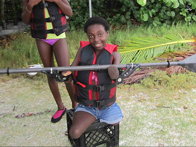 Young girl showing adaptive paddle set up for kayak