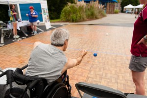 Man playing Bocce from his wheelchair