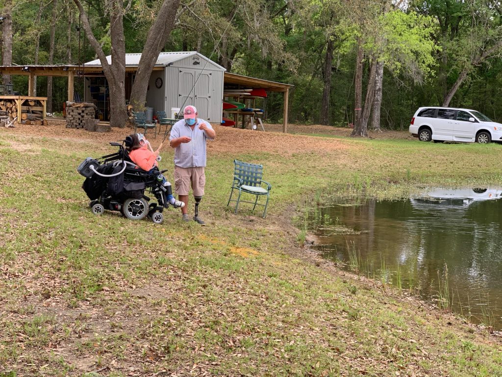 Marcella fishing at edge of lake
