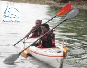 Youth kayaking without hands