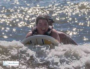 Woman surfing prone on a small wave